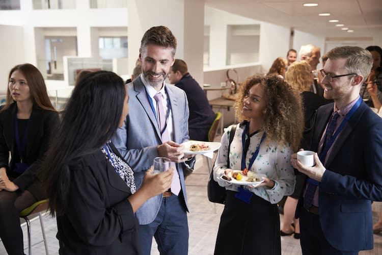 Delegates talking at conference during snack break