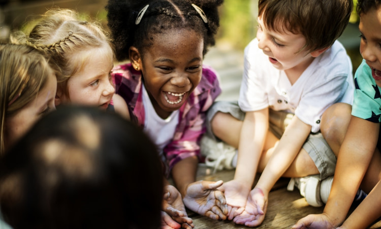 a group of students laugh during a field trip